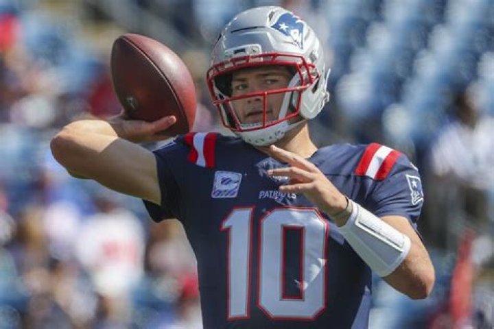 Can NFL coaches talk to QB during play?