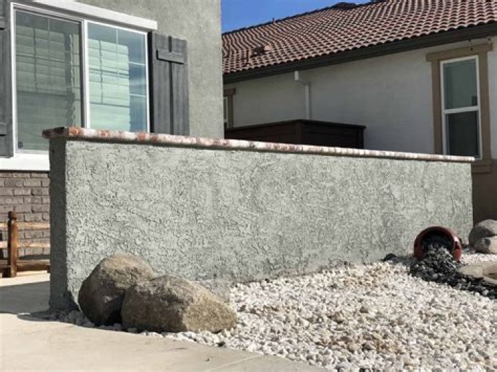 How do you prepare a concrete wall for stucco?