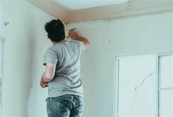 How do you prevent brush strokes when painting walls?