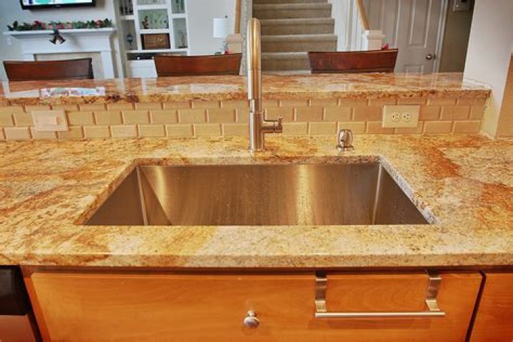 How do you reattach a sink to a granite countertop?