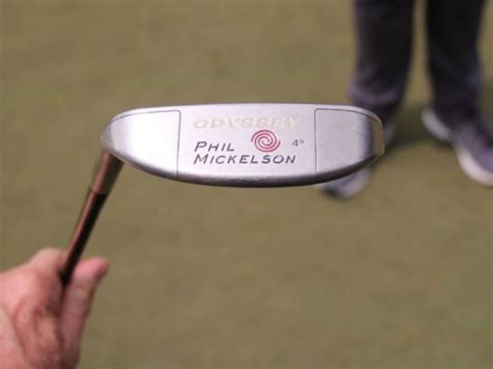How does Phil Mickelson hold his putter?
