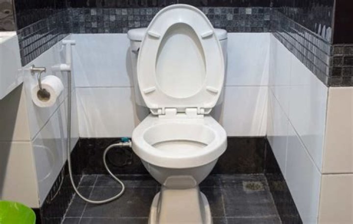 Should you tile behind a toilet?