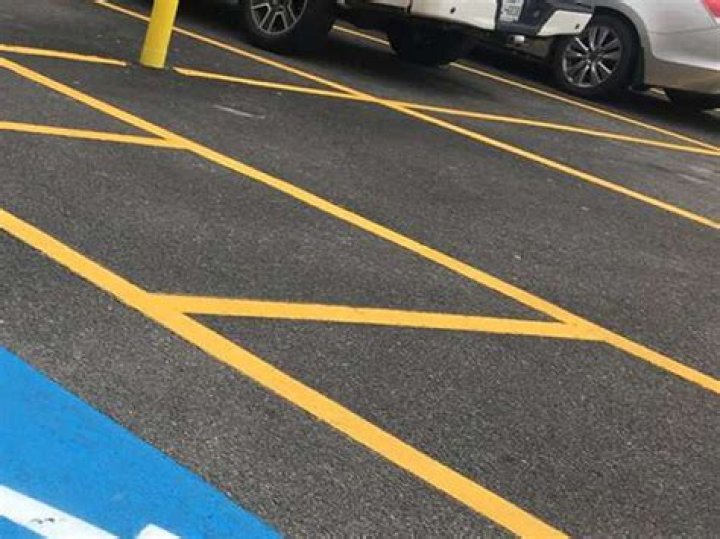 What do yellow stripes in a parking lot mean?