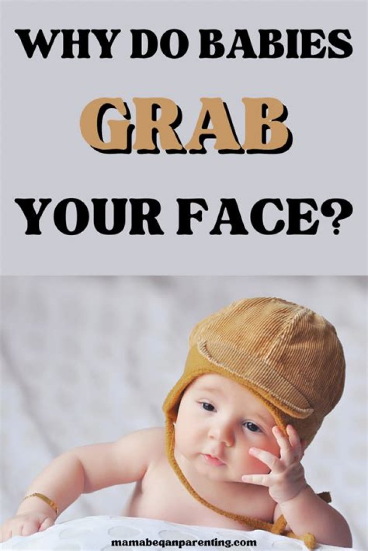 Why do babies try to grab your face?